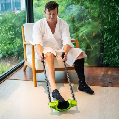 man is taking off compression stockings very easy withou bending by the extendable long handes